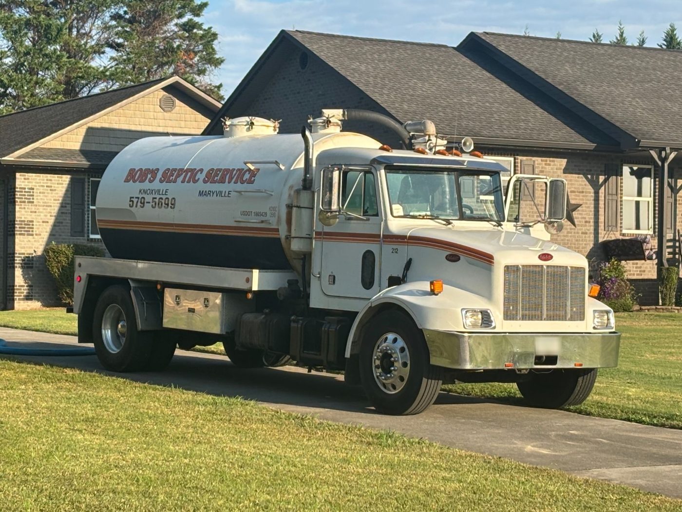 Bob's Septic Service tank truck, Knoxville and Maryville, TN, parked at a customer's home