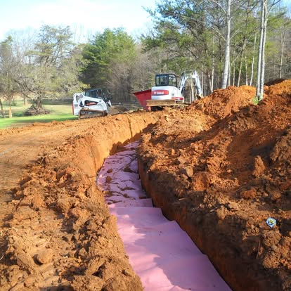 Drain field trench being prepared for a new septic system